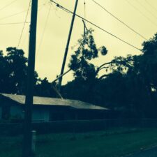 A house with power lines hanging from it's roof.